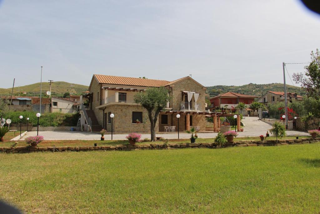 a house with a playground in a yard at Country House Il Melograno in Castellabate