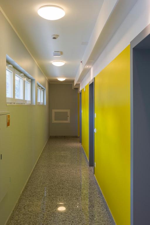 an empty hallway with green and yellow walls at Hotel Liberty Self Check-In in Bellinzona