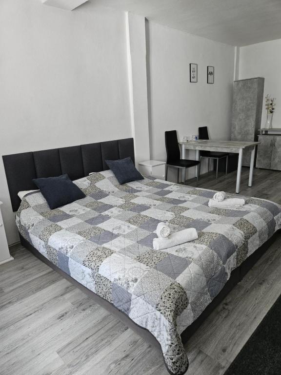a bedroom with a large bed with a table and a dining room at Zimmervermietung Schöne Gasse 6 in Freiberg
