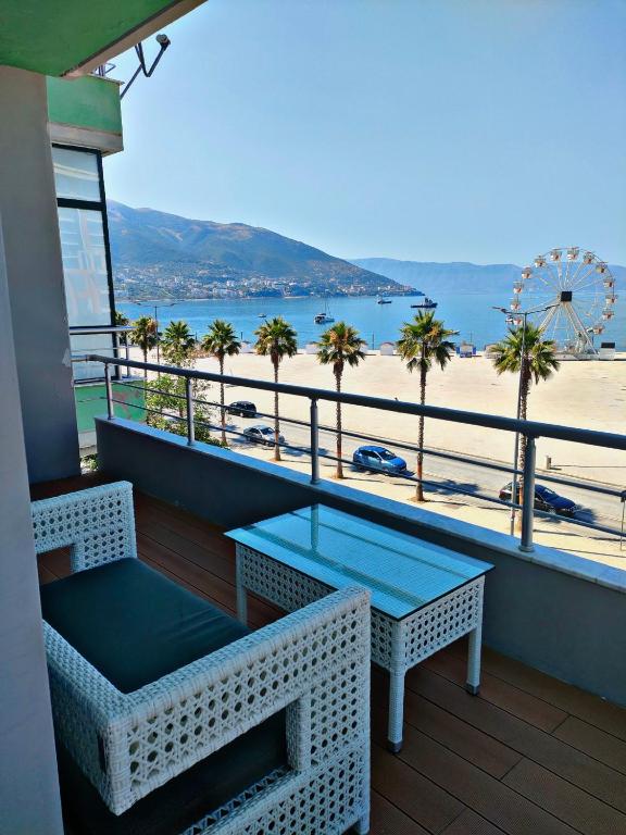 a balcony with a table and a view of the beach at Alba Suites in Vlorë