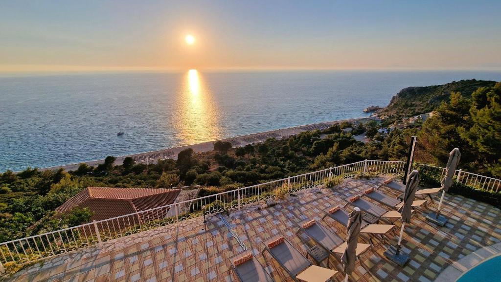 a view of the ocean from the balcony of a house at Villa Margaux Kathisma, Breathtaking VIEWS & Unforgettable SUNSETS - Minutes from Most Iconic BEACH in Agios Nikitas