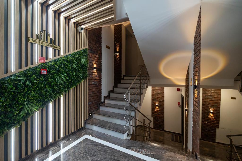 a staircase in a building with a green plant at Prestige Suites - Cluj Luxury in Cluj-Napoca