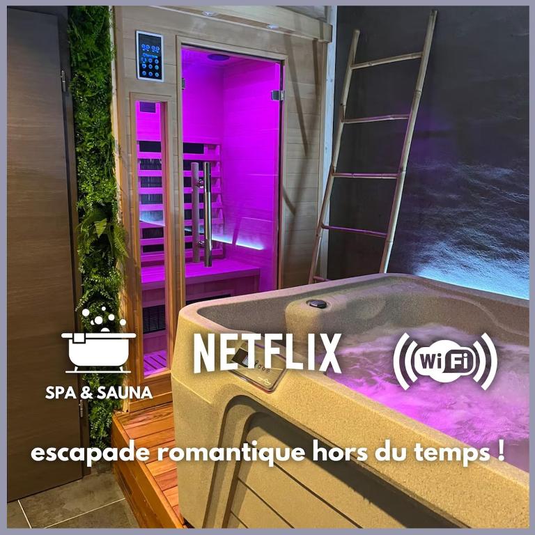 a room with a bed and a purple light at Romantic home spa in Laveline-devant-Bruyères