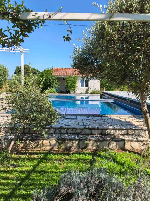 a swimming pool in the yard of a house at Villa With Swimming Pool in Ulcinj
