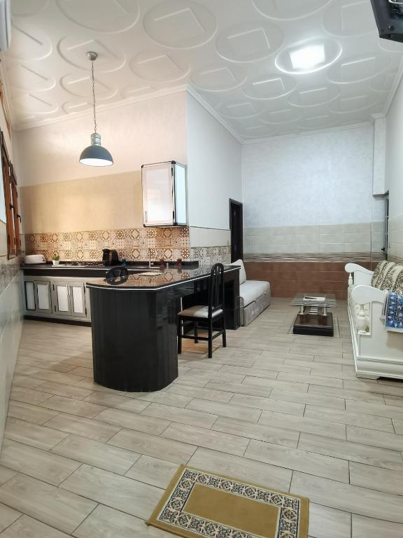 a large room with a kitchen and a living room at Marhaba in Nador