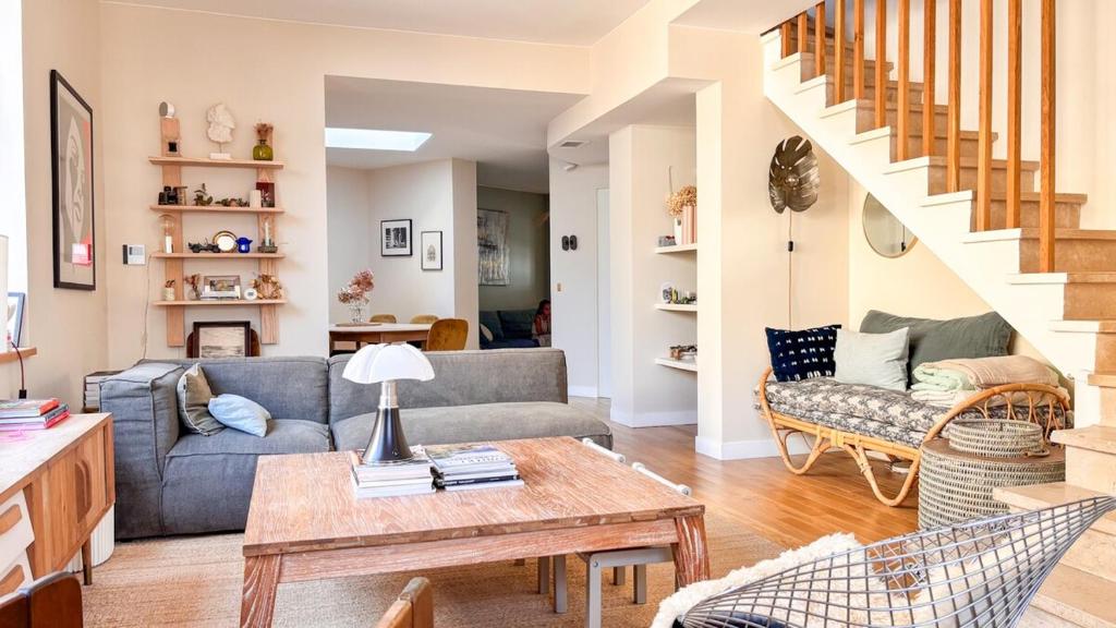 a living room with a couch and a table at Large house, very high standing in Bordeaux