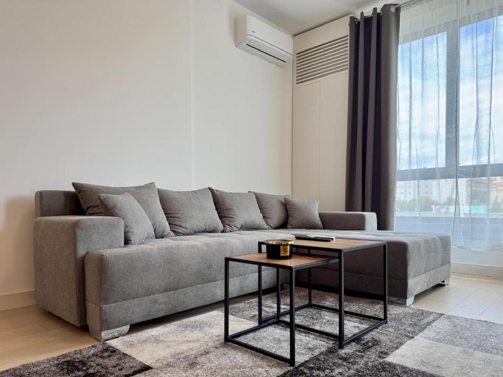 a living room with a couch and a table at Magnolia Apartment Luxury and Relaxation on the Sava in Belgrade
