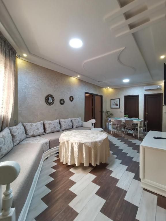 a living room with a couch and a table at Passo Nador 3 chambres in Nador