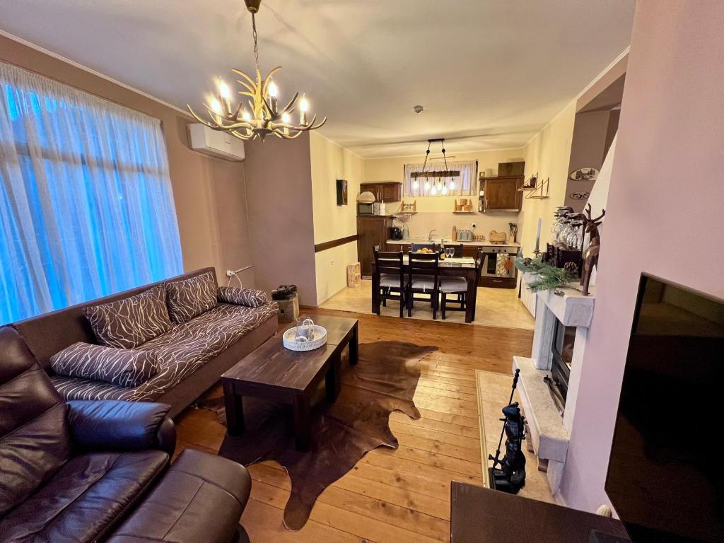 a living room with a couch and a table at Chalet Hamars - Highland Haven in Razlog