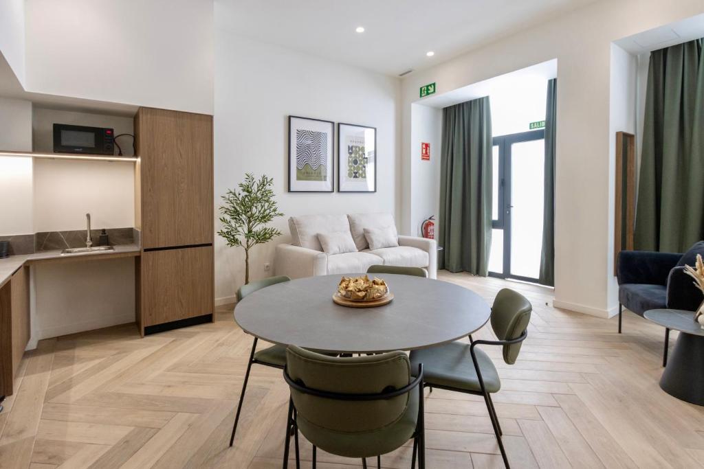 a living room with a table and chairs in a room at Boutique Room - One Tower in Valencia