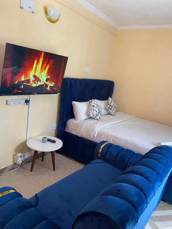 a living room with a couch and a fire place at Marie's Studios Naivasha in Naivasha