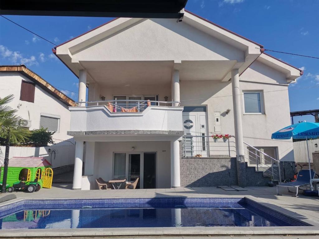 a house with a swimming pool in front of it at The White House in Kavadarci