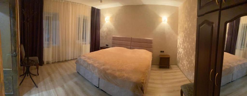a bedroom with two beds and a mirror at Eco House in Gyumri