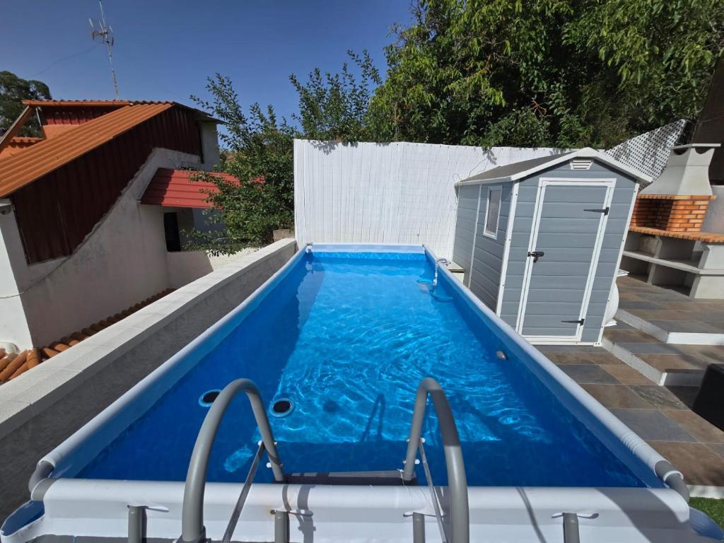 a large blue swimming pool next to a building at Villa Rita in Cueva Grande