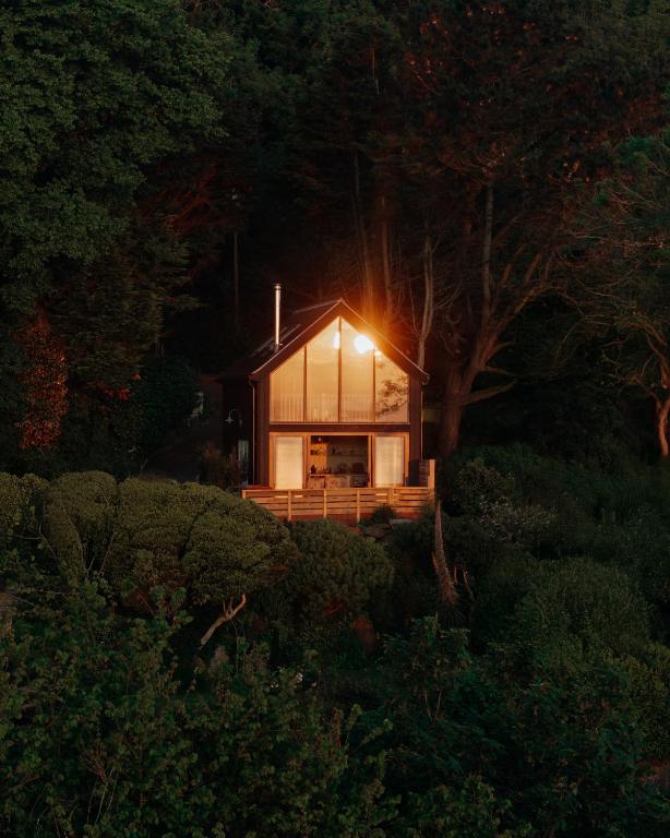 a house with a light on the front of it at 1-bed luxury seafront cabin in heart of Newlyn, Mousehole in Newlyn
