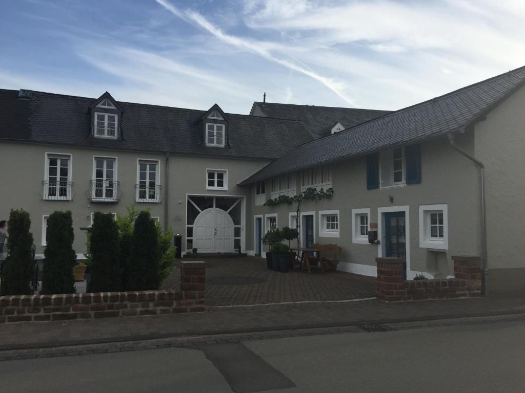 a large white house with a patio in front of it at Ferienwohnung Stübchen in Salmtal