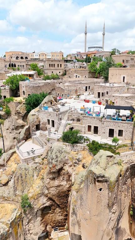 a group of buildings on top of a mountain at Kapadokya Ihlara Konakları Otel Antik Konaklar in Guzelyurt