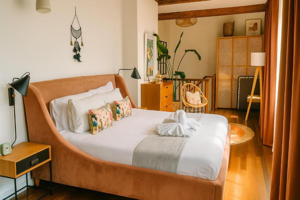 a bedroom with a large bed with a wooden headboard at City Penthouse with 3 floors , Super King Bed , with secret garden in Birmingham