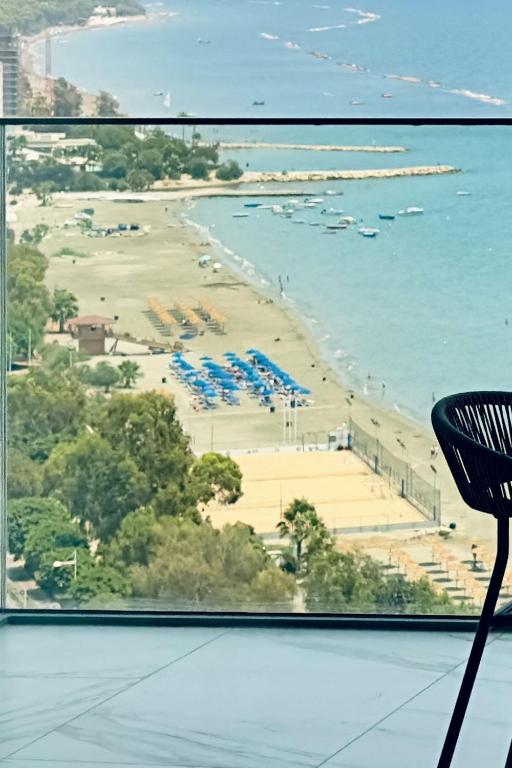a view of a beach from a window at Luxury 1 Bed in Trilogy, Limassol Seafront in Limassol