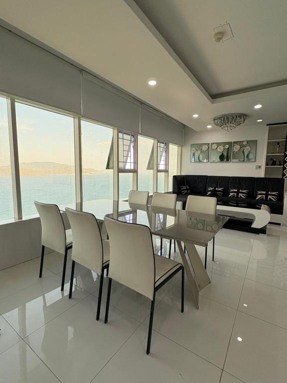 a dining room with a table and chairs and a piano at Muong Thanh Oceanfront Retreat apartment in Nha Trang