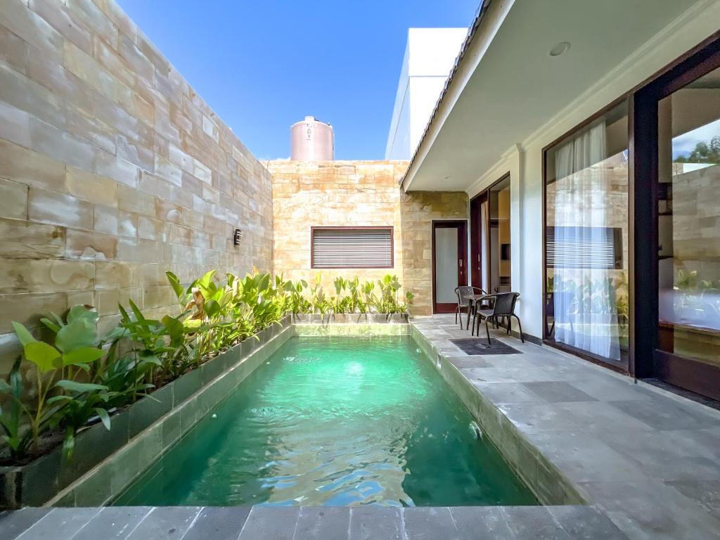 a swimming pool in the middle of a house at Villa Araya in Nusa Dua