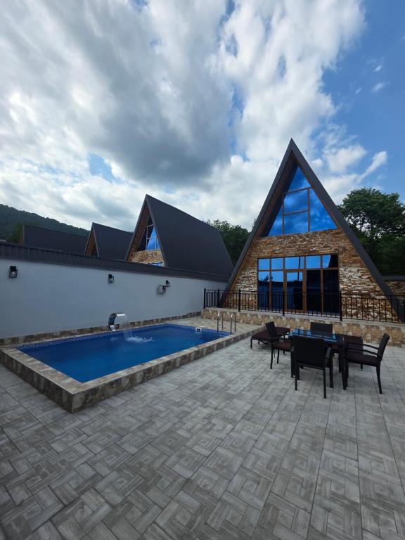 a house with a swimming pool next to a building at SOLAR Hotel and Restaurant in Gabala