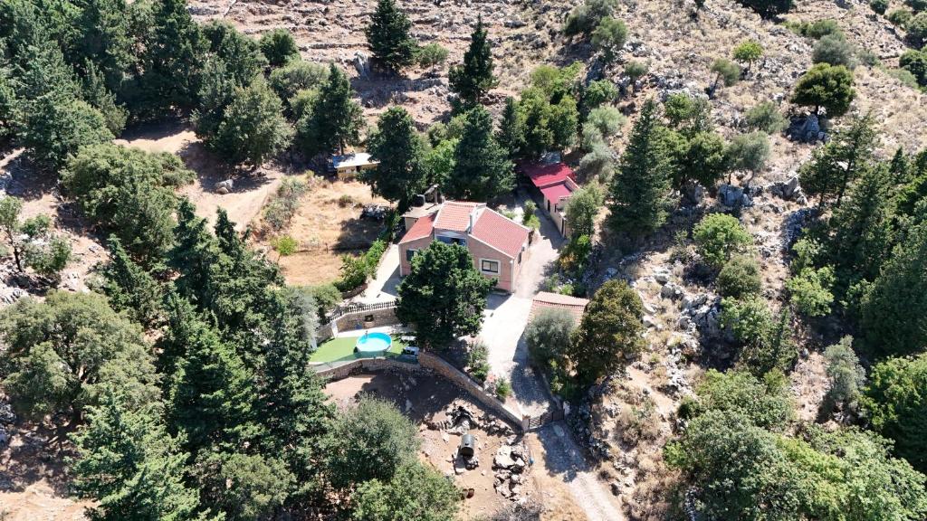 an aerial view of a house on a hill with trees at Mountain refuge of the White Mountains Anna's country villa in Karés