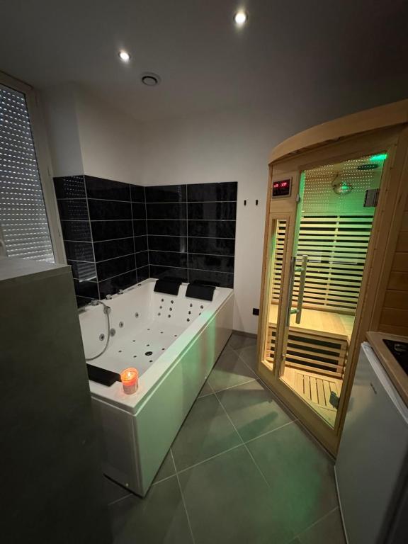 a bathroom with a tub with a candle in it at Spa, chill & centre-ville in Vichy
