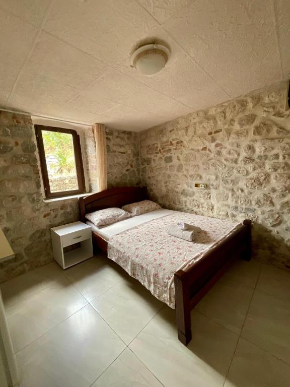 a bedroom with a bed and a window at Apartments Bella in Kotor