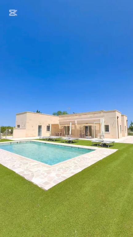 a house with a swimming pool in the yard at Masseria Fra Telesforo in Mesagne