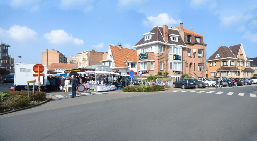 a city street with a building and a crosswalk at Logies Het Maantje in De Panne