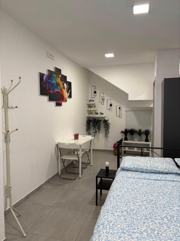 a room with two beds and a table in it at Guest House Mamma Maria in Gaggi