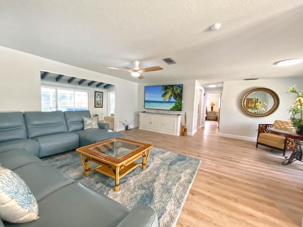 a living room with a blue couch and a coffee table at Siesta Key Paradise, Vacation Pool Home, Near Beach, Restaurants and More in Sarasota
