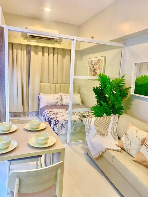 a living room with a couch and a table at Primeworld District Condoresort 15mins2airport in Mactan Island