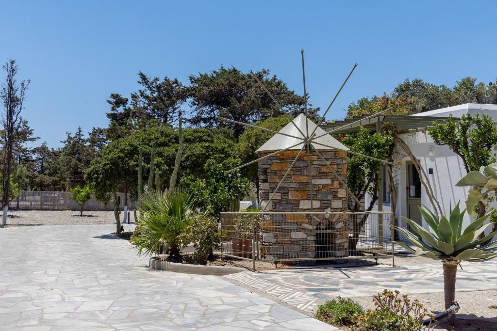 a stone fireplace in the middle of a courtyard at Green Dream Tinos in Tinos