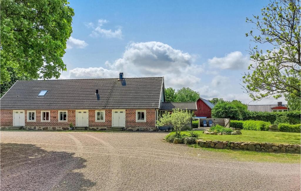 a house with a driveway in front of it at 2 Bedroom Cozy Home In Munka-Ljungby in Munka-Ljungby