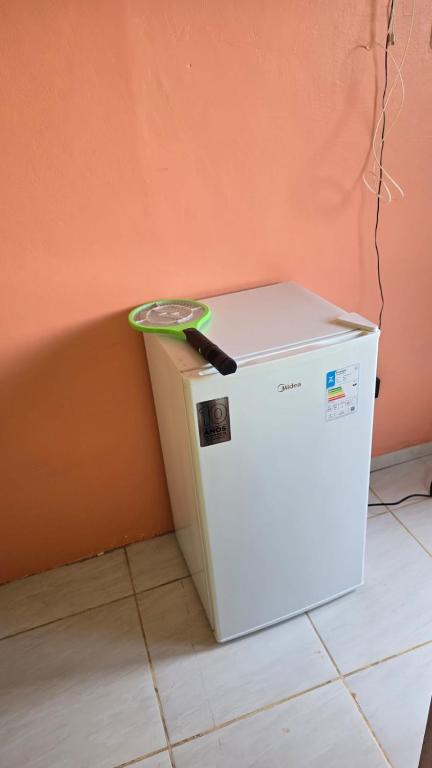 a white refrigerator with a knife on top of it at Apto B com cozinha em Macapa Terra Nova in Macapá