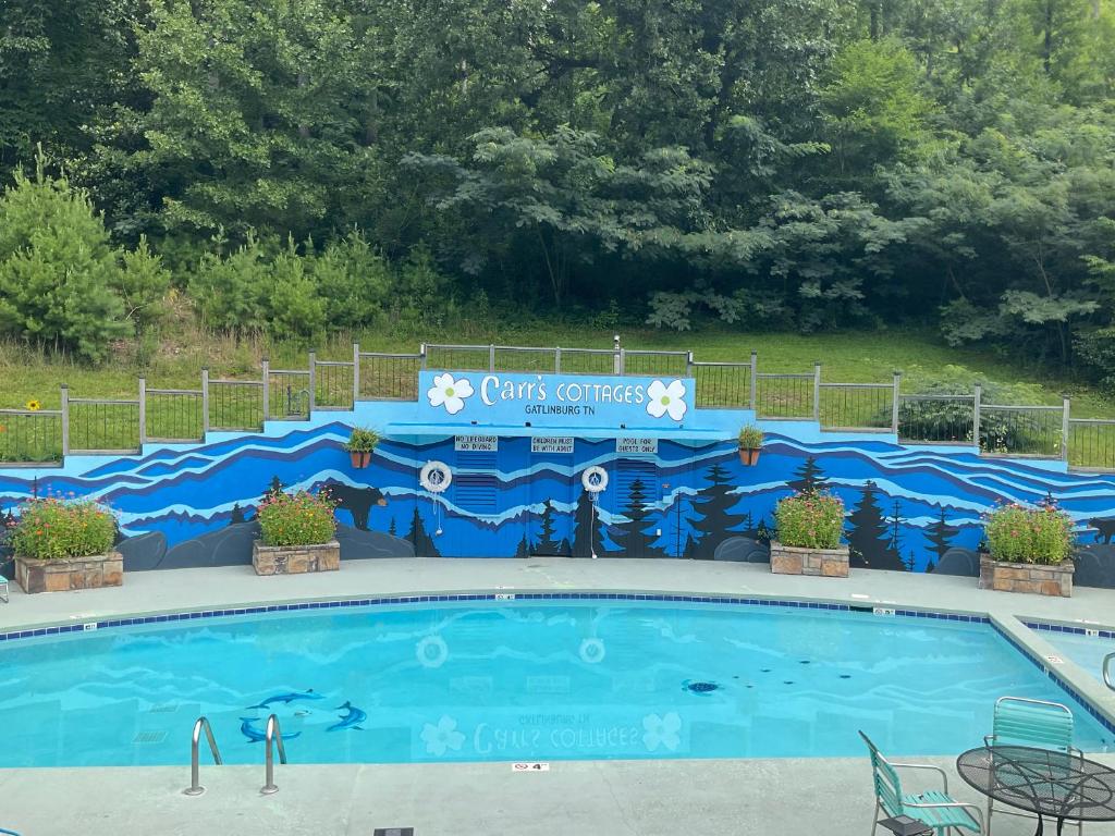 a swimming pool with a sign that says christmas surprises at Carr's Northside Hotel and Cottages in Gatlinburg