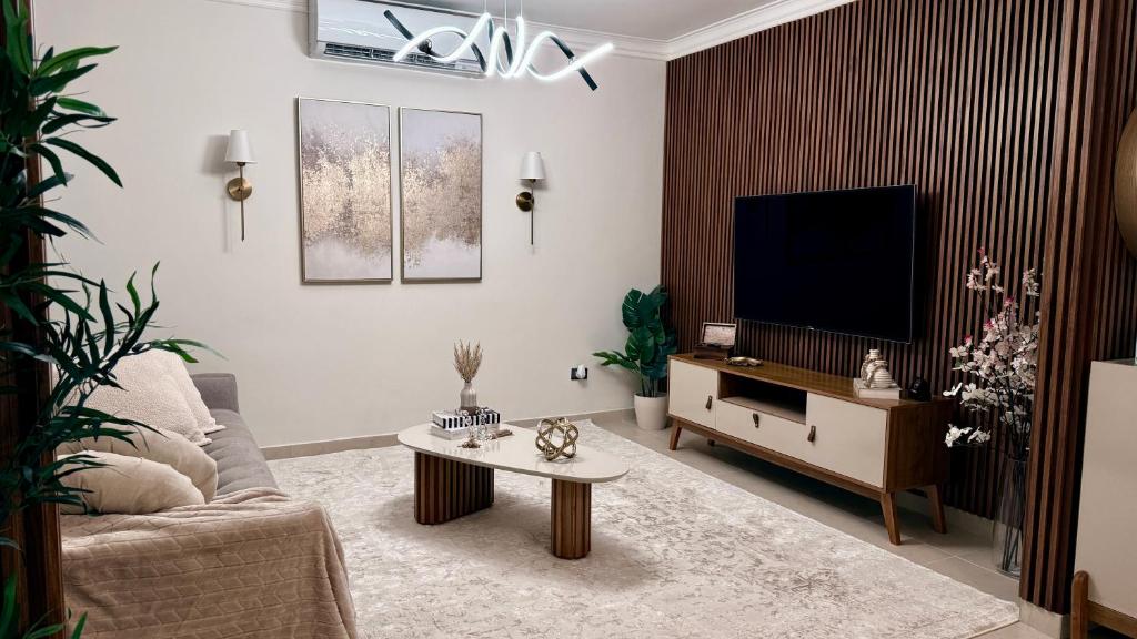 a living room with a couch and a tv at Cozy and Beautiful, 3 Bedroom Apartment Home in Santo Domingo