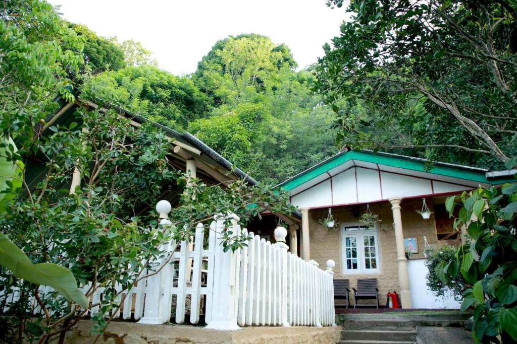 a house with a white fence in front of it at B City Villa Ella in Ella