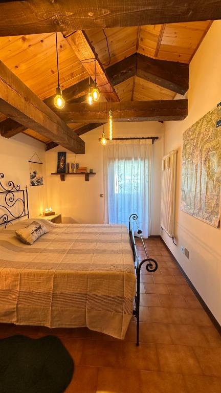 a bedroom with a large bed in a room at Mansarda Chiara - locazione turistica in Gosaldo