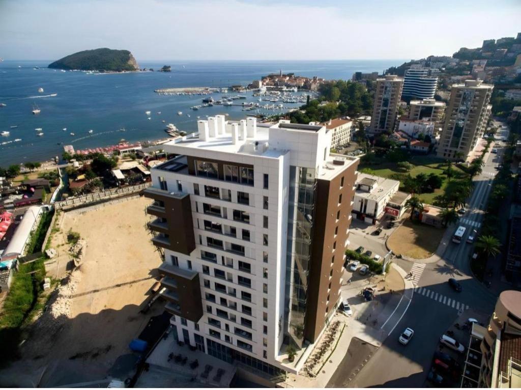 an aerial view of a large white building next to the water at Seabreeze apartments Budva in Budva