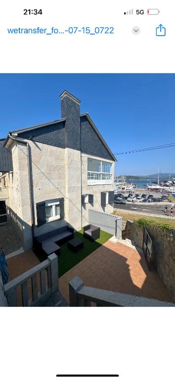 a building with a staircase in front of it at Chancelas A in Combarro