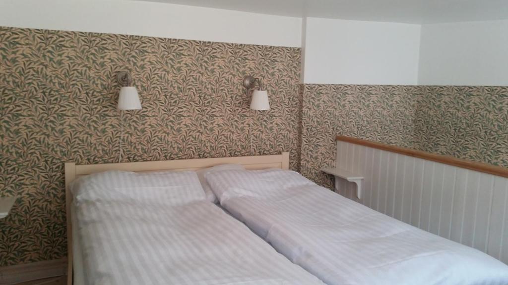 Postel nebo postele na pokoji v ubytování Lilla Hotellet