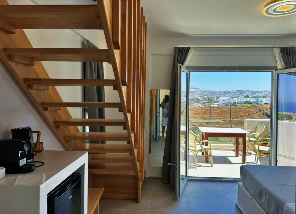 a staircase in a house with a view of a patio at Lovely Hot-L in Fira