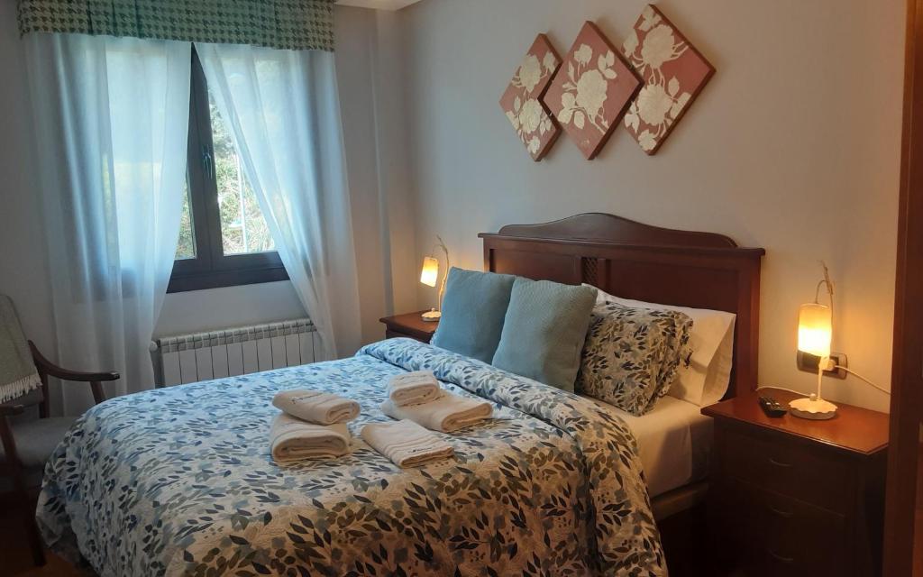 a bedroom with a bed with two towels on it at Sellamante2 in Ribadesella