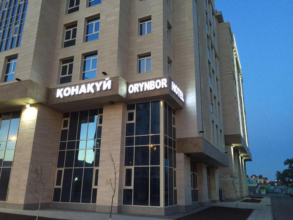 a building with a sign on the front of it at Orynbor Boutique Hotel in Astana