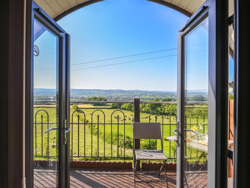 a view from the balcony of a house with sliding glass doors at Luna Holiday Pod - Uk48590 in Church Stretton