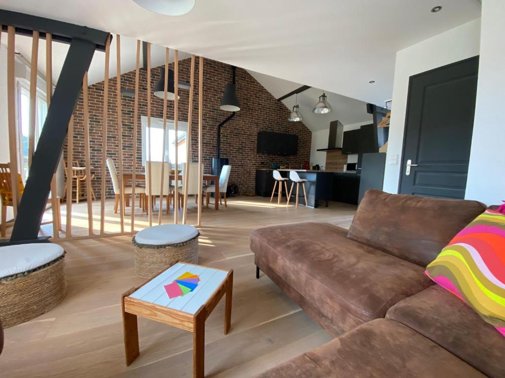 a living room with a couch and a table at Les Épinettes Appartement 6 in Prémanon