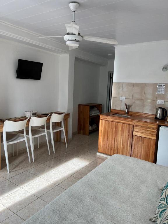a kitchen with a table and chairs in a room at Bungalows Plaza Termal in Federación